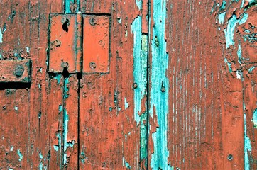 background of a piece of old wooden shutters with cracked red paint