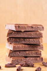A stack of milk chocolate. Photo in warm colors. Sweetness. World chocolate day