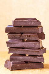 A stack of milk chocolate. Photo in warm colors. Sweetness. World chocolate day