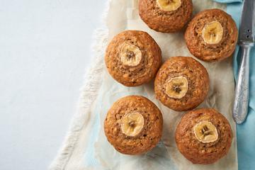 Banana muffin, top view, copy space. Cupcakes on blue napkin, white concrete table