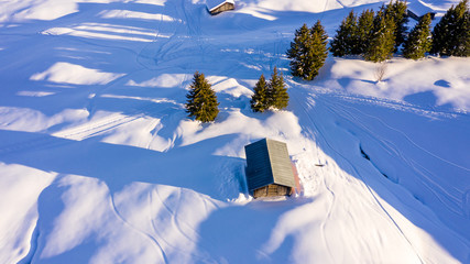 Aerial view of snow covered houses in small rural town in Switzerland.