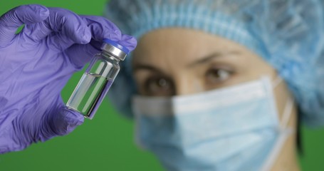Female scientist holding ampoule in hand, new medication developing, vaccination