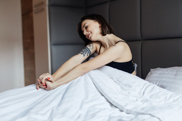 Portrait of a pretty young woman relaxing in bed