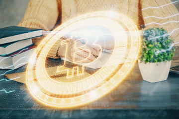 Cryptocurrency hologram over hands taking notes background. Concept of blockchain. Multi exposure