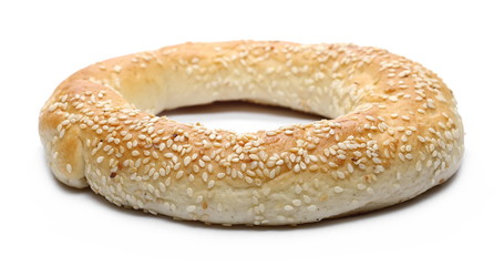 Bagel with sesame and wheat ears isolated on white background