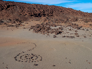A spot in Tenerife with many rocks and a beautiful mountain landscape in the background