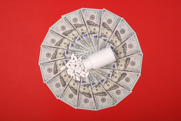 White pills on mandala kaleidoscope from money.