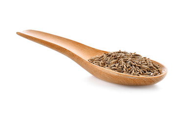 caraway seeds in wood spoon on white background