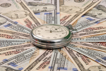 Stopwatch on mandala kaleidoscope from money.