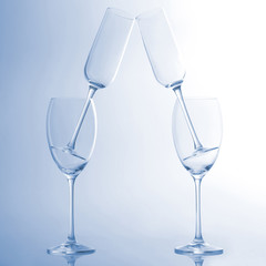 four empty wine glass on a light blue background