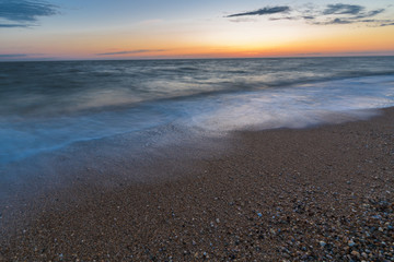 photo on long exposure, waves at sea at sunset
