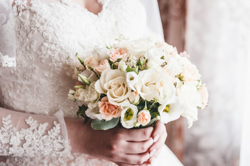 Bride keeps bouquet