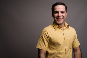 Obraz premium Portrait of handsome Persian man against gray background