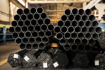 Metalic pipes on warehouse, rows of metal pipes on industrial warehouse. Industrial interior,