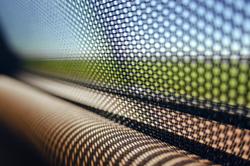 Sun blinds on the glass of the rear door of the car black color close-up protects the textured grid from the sun's rays. Car service