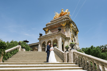 Bride and groom posing on the stone stairs