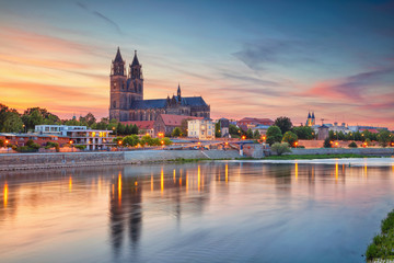 Magdeburg, Deutschland. Stadtbild von Magdeburg, Deutschland mit Reflexion der Stadt in der Elbe, während des Sonnenuntergangs.