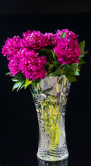 bouquet of peonies is in a vase