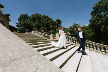 Bride and groom posing on the stone stairs