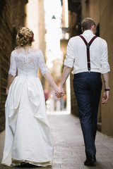 Bride and groom posing on city streets