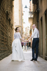 Bride and groom posing on city streets