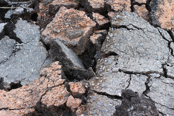 pieces of asphalt road on the ground to be recycled.