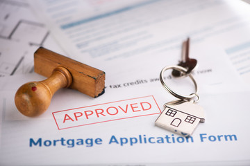  An approved Mortgage loan application form with house key and rubber stamp