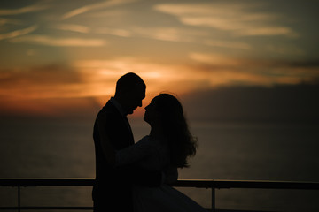 Young beautiful couple on the deck of a cruise liner in the sea