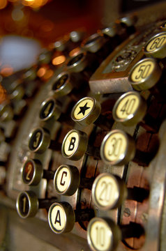 Antique cash register on brown background, close-up photo