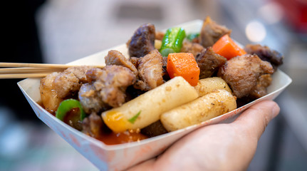 Pan-fried black pork meal in Korea traditional market, delicious korean food cuisine with carrot and shallot green onion, close up, copy space