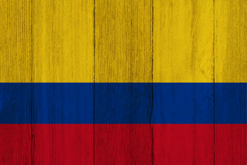 A rustic old Colombia flag on weathered wood