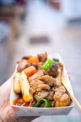 Pan-fried black pork meal in Korea traditional market, delicious korean food cuisine with carrot and shallot green onion, close up, copy space