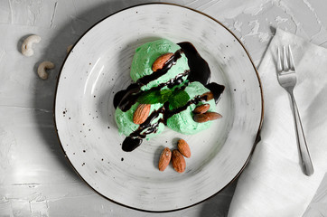 Set of ice cream scoops of different colors and flavours with berries, nuts and fruits