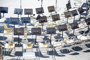 Top view of the chairs music stands brass band instruments. Preparation of the festival of military...