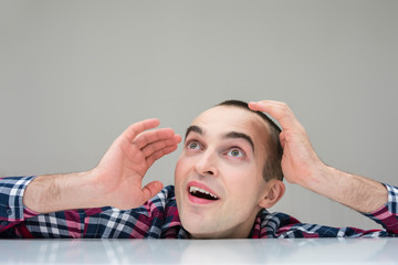 Man looks up in surprise, copy space, front view