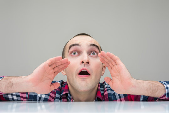 Man looks up in shock, copy space, front view