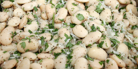 White beans salad with parsley. Full frame cover photo of food. White beans background texture. Detox.