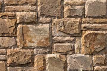 Background, texture, masonry of yellow natural stone blocks