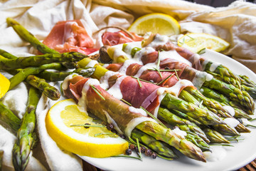 Cooked asparagus with sauce and meat, italian food, healthy diet concept