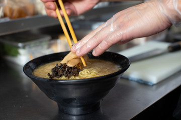 preparing and cooking japanese ramen with meat and vegetables