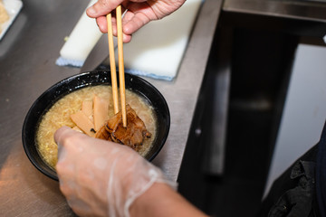 preparing and cooking japanese ramen with meat and vegetables