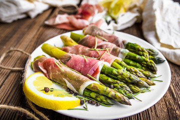 Gourmet asparagus with meat - parma ham - italian appetizer on plate, top view