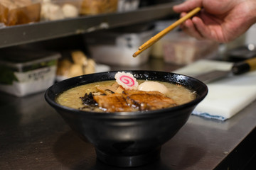 preparing and cooking japanese ramen with meat and vegetables