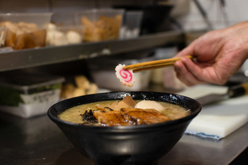 preparing and cooking japanese ramen with meat and vegetables