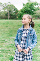 little girl playing in the park in green background