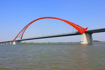 the red arch of the bridge over the river