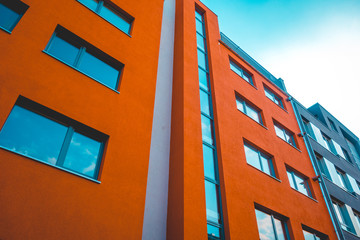 modern orange apartment building with glass staircase