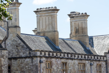 Rooftop stacks on medieval building. Close-up of historic roof detail.