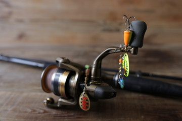 spinning with reel and lure on wooden background