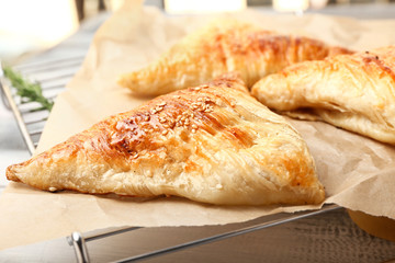 Delicious samosas on cooling rack, closeup